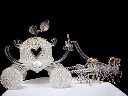 Cinderella coach wedding cake top with four solid glass horses.
