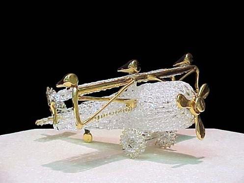 knitted glass airplane with solid glass wings, propeller and lots of gold