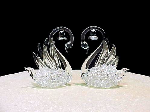 swan wedding cake top hand blown glass swan figurines with wedding bells on their neck.