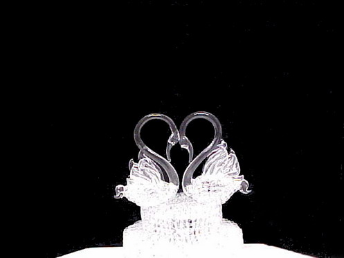 swans wedding cake top with two hand blown glass swans on a glass base.